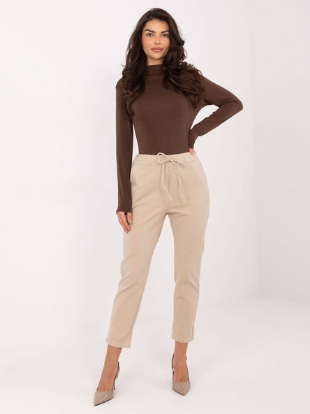 Beżowe materiałowe spodnie z gumką w pasie
